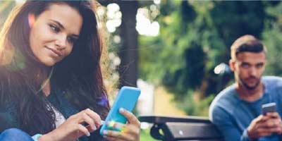 Young couple messaging back and forth on their mobile devices