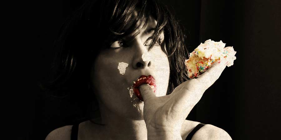 Woman eating a creampie and licking her fingers in an erotic manner