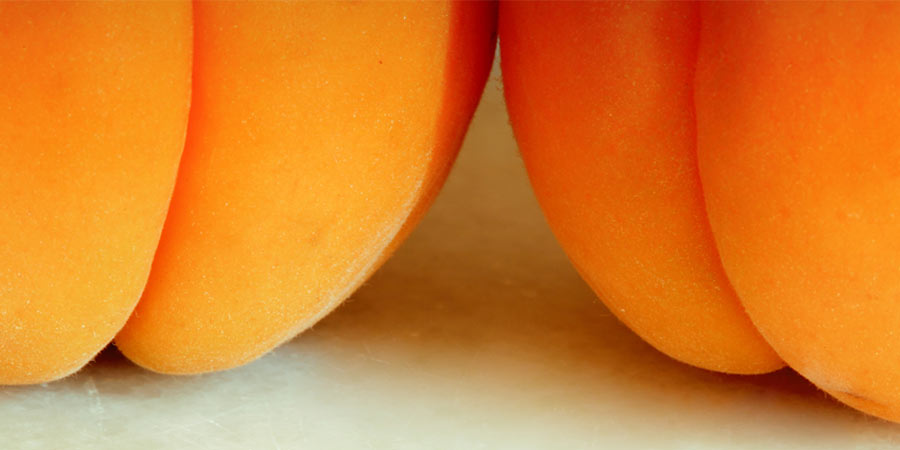 Close up photo of a luscious ripe peach made to look like a juicy ass
