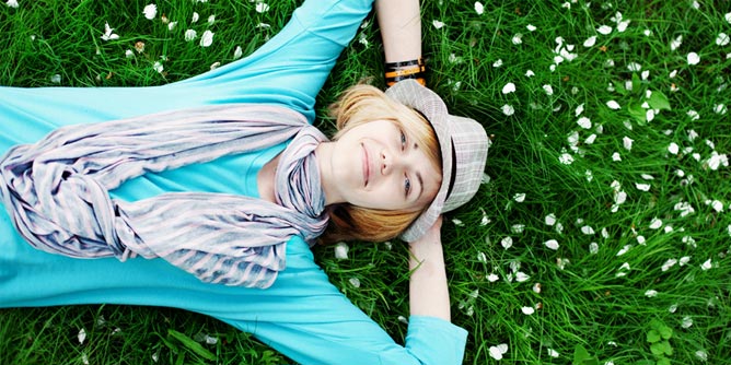 Woman who cares about the environment lying on the grass