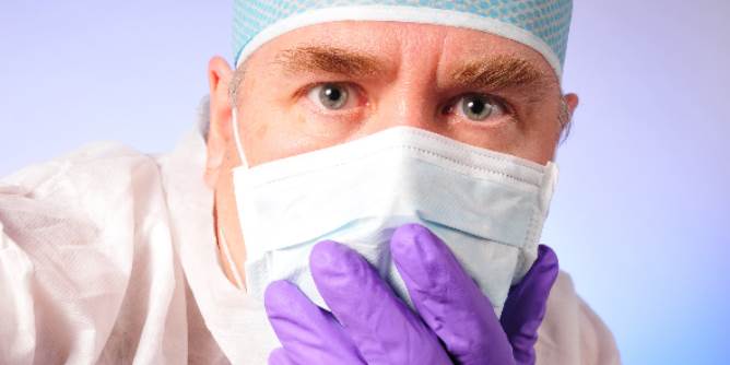 Doctor examining his patient closely to see if anything is broken